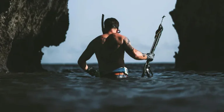backview of man's half body submerged on sea