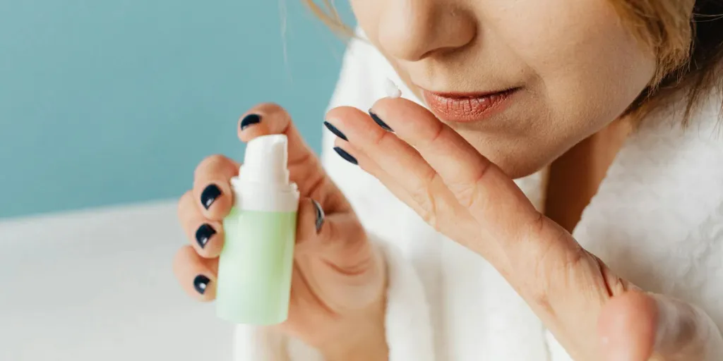 close-up of woman smelling a cream