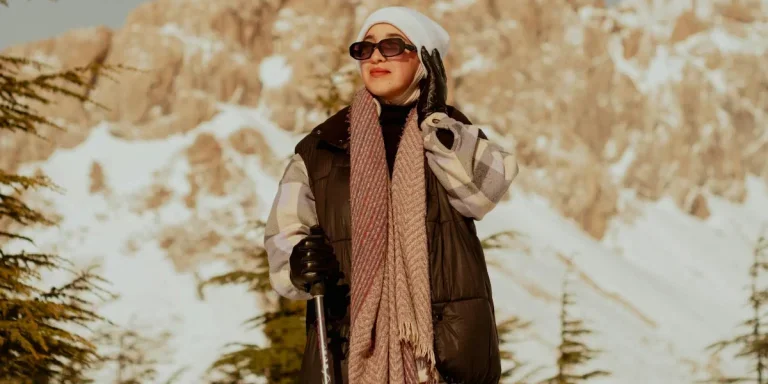 hiker with a trekking pole in the snowy mountains