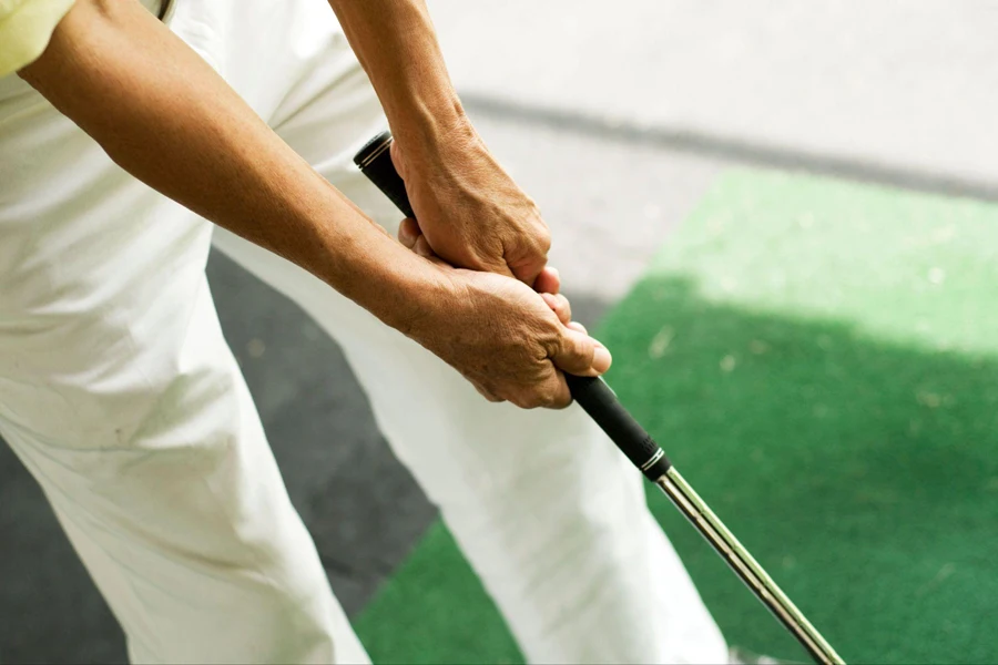 holding the grip of a golf club