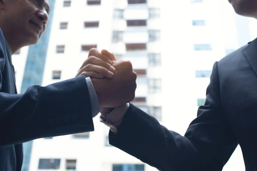 Businessmen making handshake in the city