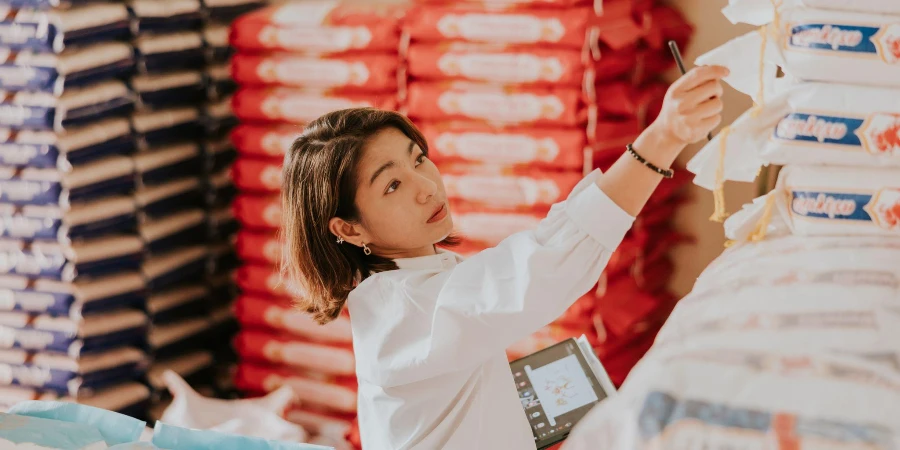 Wholesale Thai rice owner at her rice shop for working everyday
