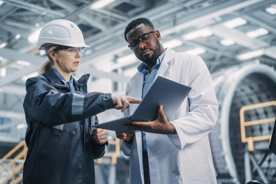 Team of Diverse Professional Heavy Industry Engineers Wearing Safety Uniform