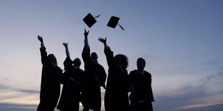 Silhouette of Graduating Students Throwing Caps In The Air