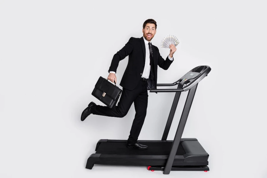 elegant man hold briefcase dollar bills run treadmill