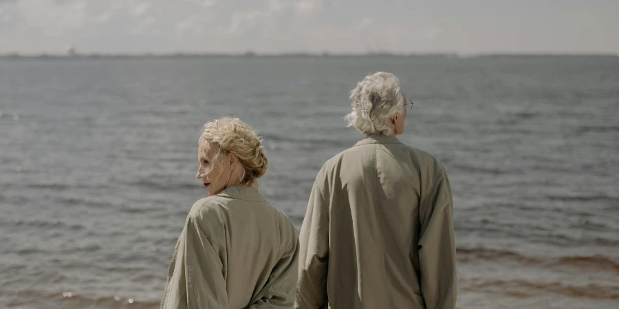 A Couple Wearing Trench Coats at the Beach