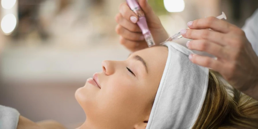 Unrecognizable beautician performs facial treatment