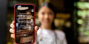 Waitress displaying an app to rate your experience at a restaurant