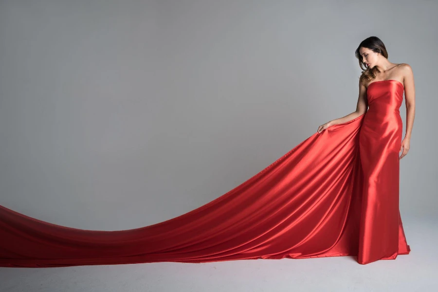 Elegant fashion model in a red long dress