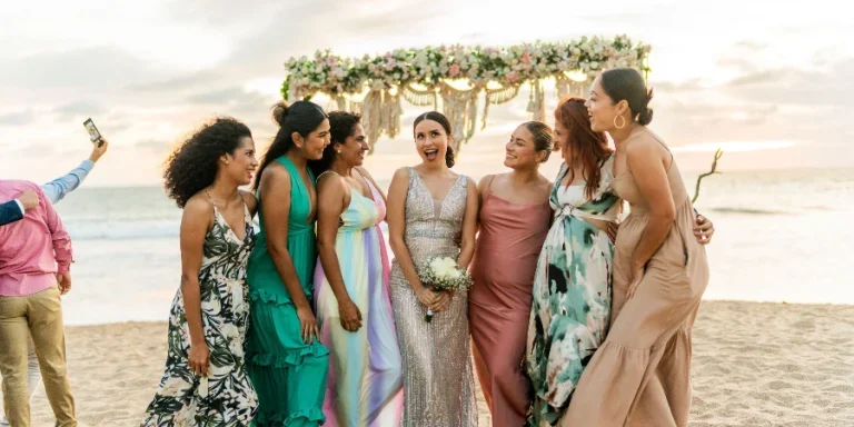 Bride talking with her friends in the wedding party on the beach