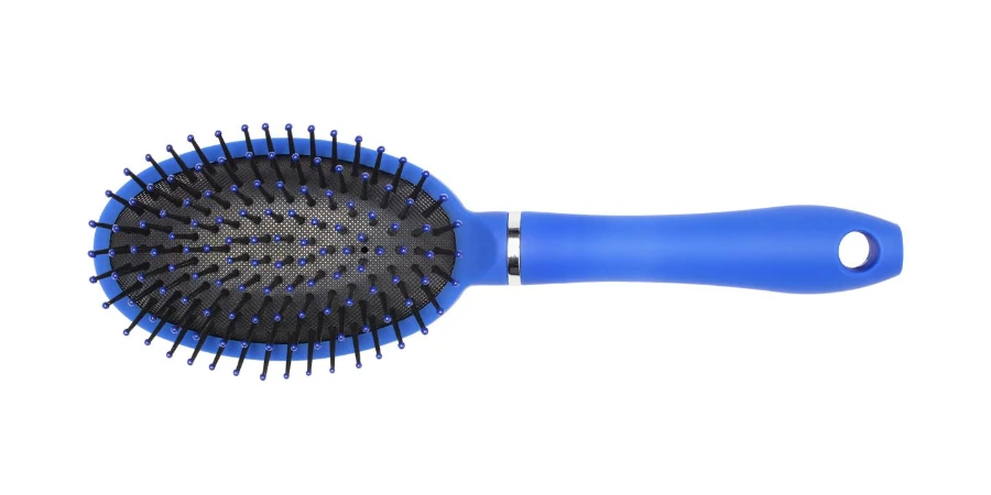 Blue massage plastic comb isolated on white