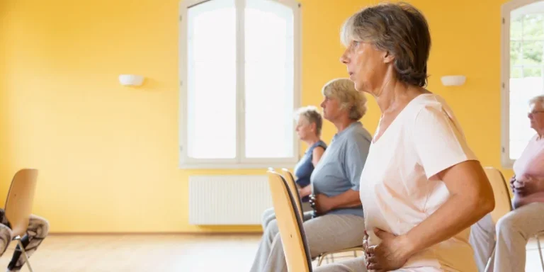 Closeup of active senior women yoga class on chairs
