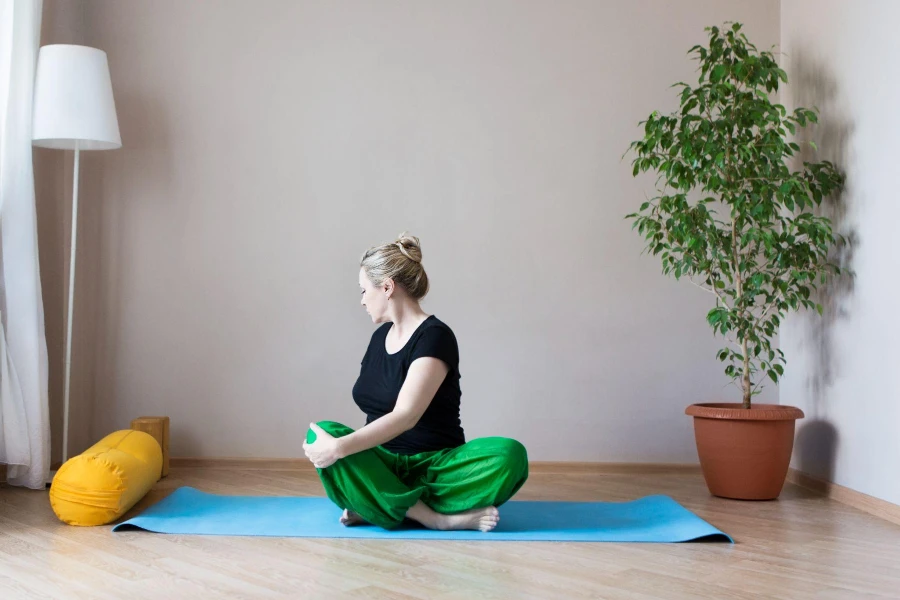 Middle aged or mature woman doing yoga indoors