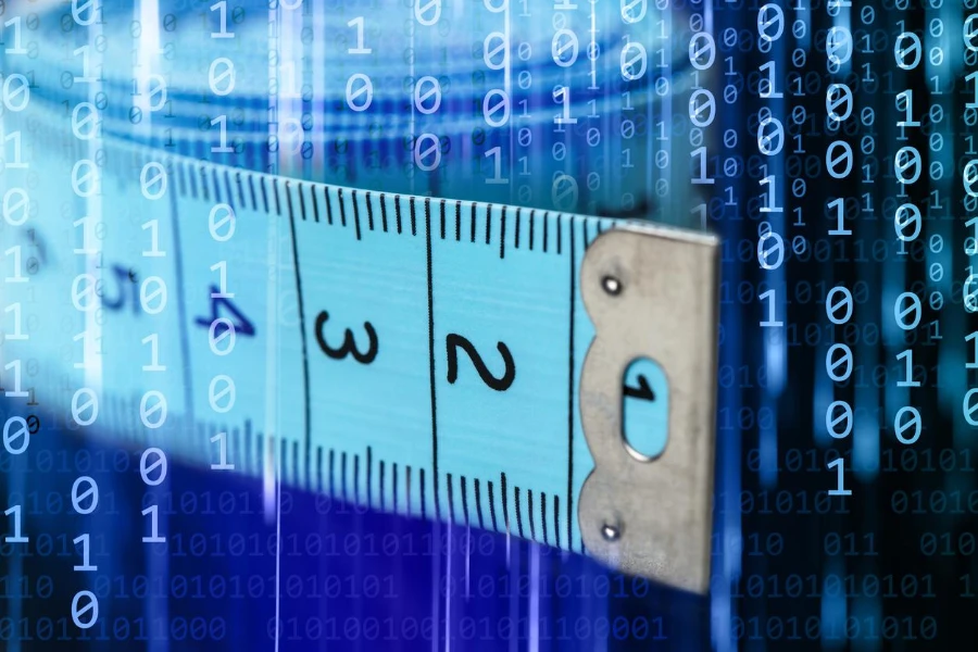 Close-up of a tape measure on a binary code background.