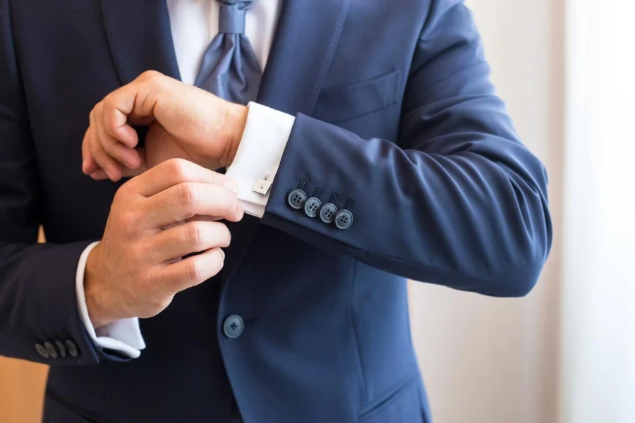 The man in the white shirt and cufflinks.