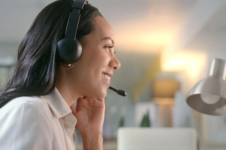 woman and call center headset office at night for customer service