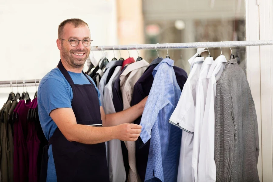 Dry cleaner posing at camera