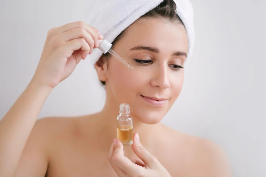 young woman with towel on head holding salicylic acid