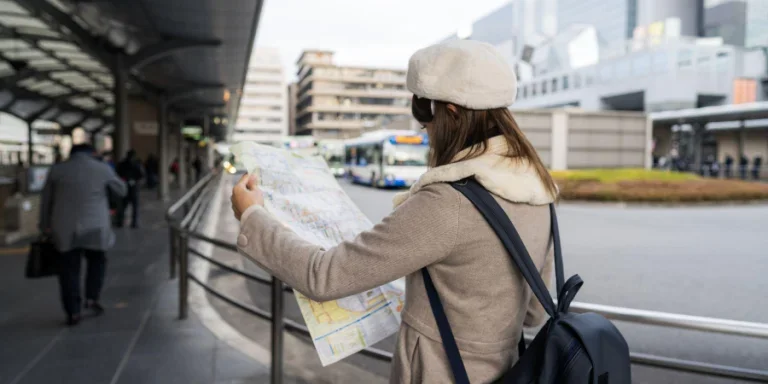 Young tourist Woman stand reading bus map at bus stop