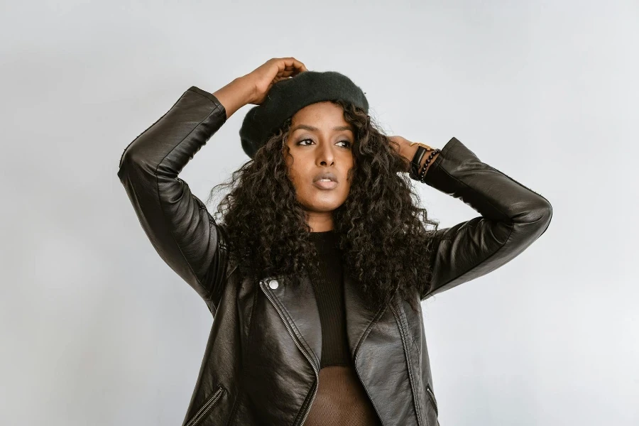 A Beautiful Woman Wearing Black Leather Jacket Posing at the Camera while Looking Afar