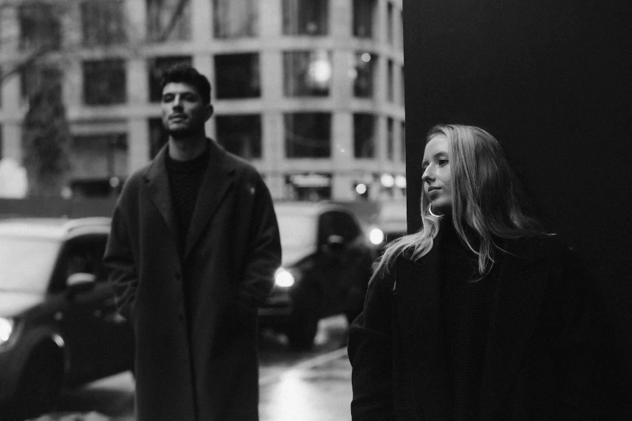 A man and woman standing in the street