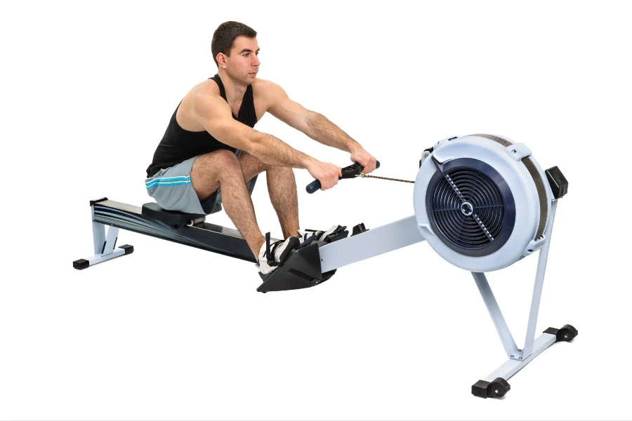 man exercising on rowing machine