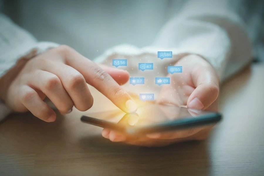 Asian woman using mobile phone for checking social media interactions