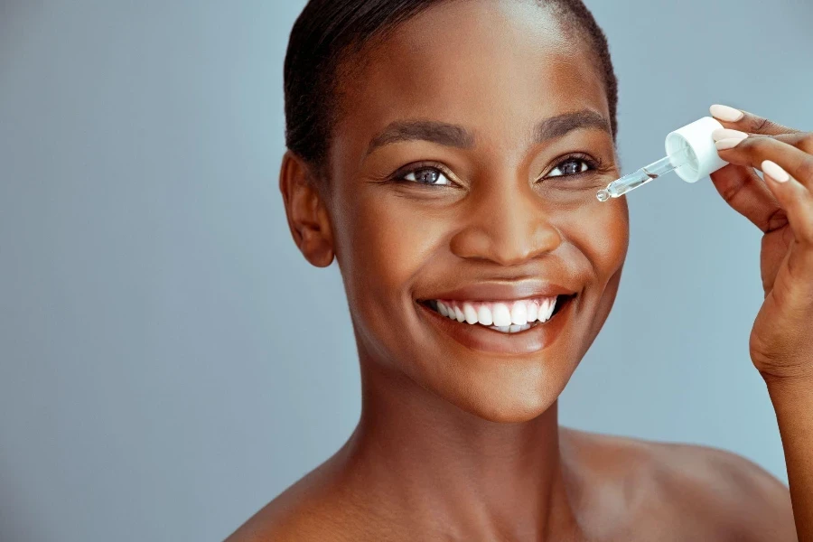 African American woman applying  hyaluronic acid