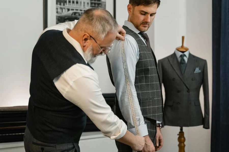 Costureiro medindo o braço de um homem