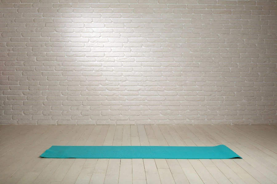 Empty room background wooden floor white brick wall with fitness mat