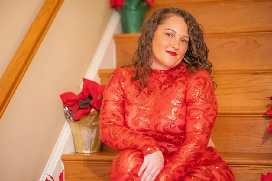 Woman in Red Dress Sitting on Staircase