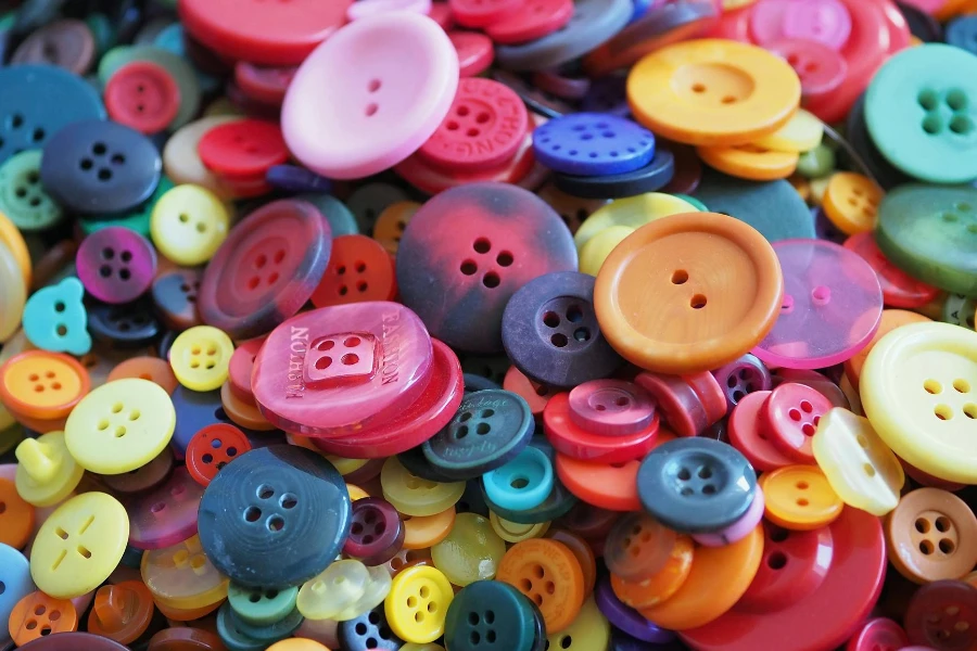 A pile of colorful buttons with a variety of colors