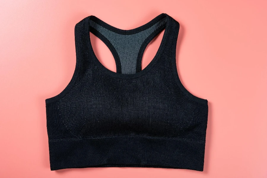 black sports bra for women on pink background