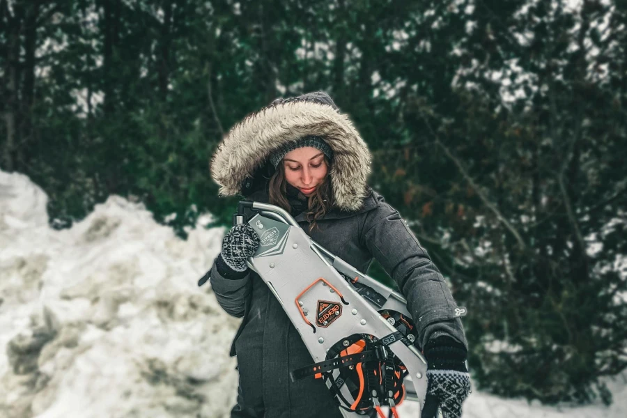 Woman in Black Hoodie Jacket Holding a Sled