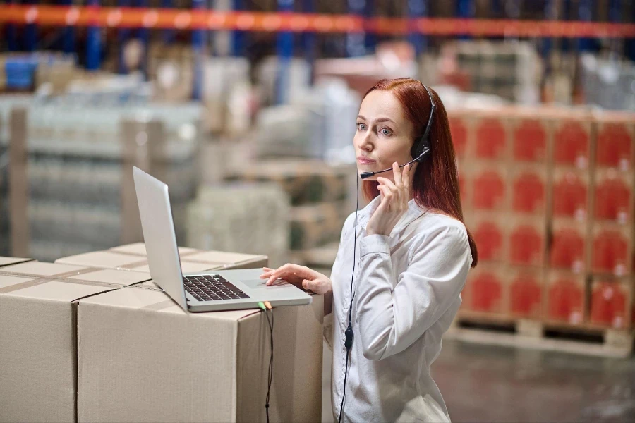 Young serious woman in headset listening attentively