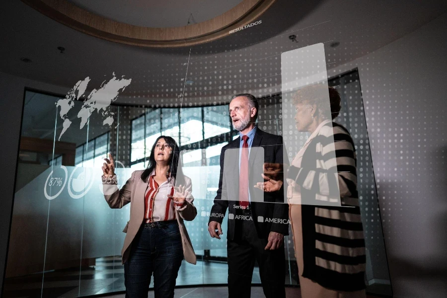 Coworkers looking to a hologram during a meet at office