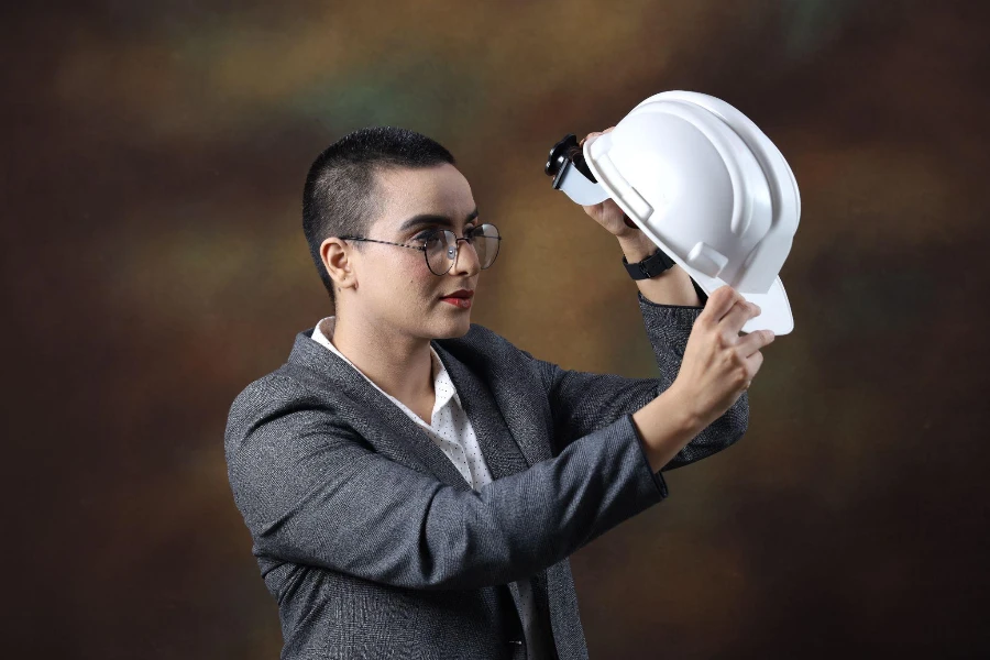 confident young woman wearing construction helmet