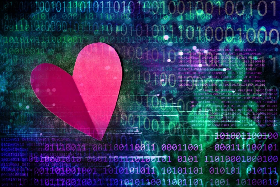 Red paper heart on a binary code background with defocused dollar signs.