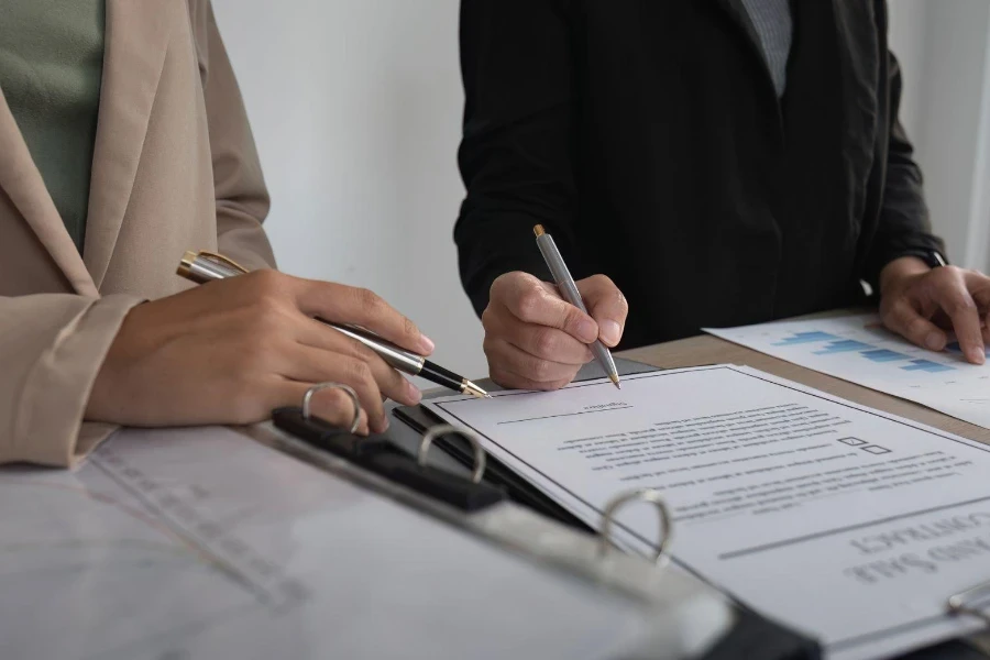 Close-up of the agreement document being signed.