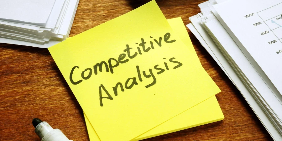 Competitive Analysis report and stack of business papers.