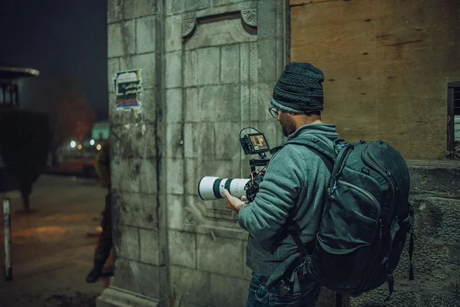 man with camera backpack