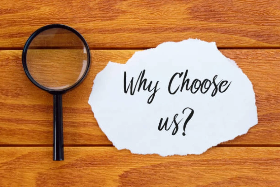 the question Why Choose Us? on wooden background