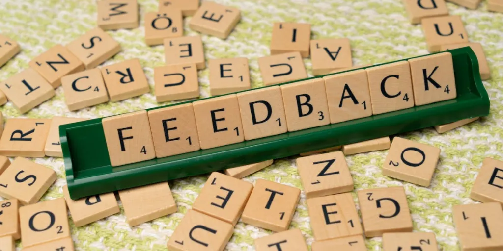 Das Wort „FEEDBACK“ buchstabiert in Scrabble-Kacheln