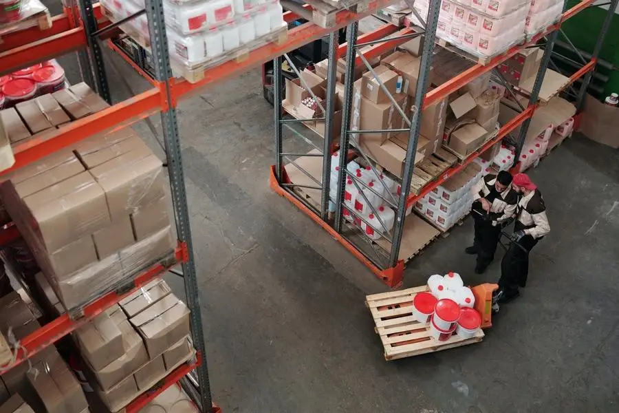 Warehouse workers moving and organizing inventory