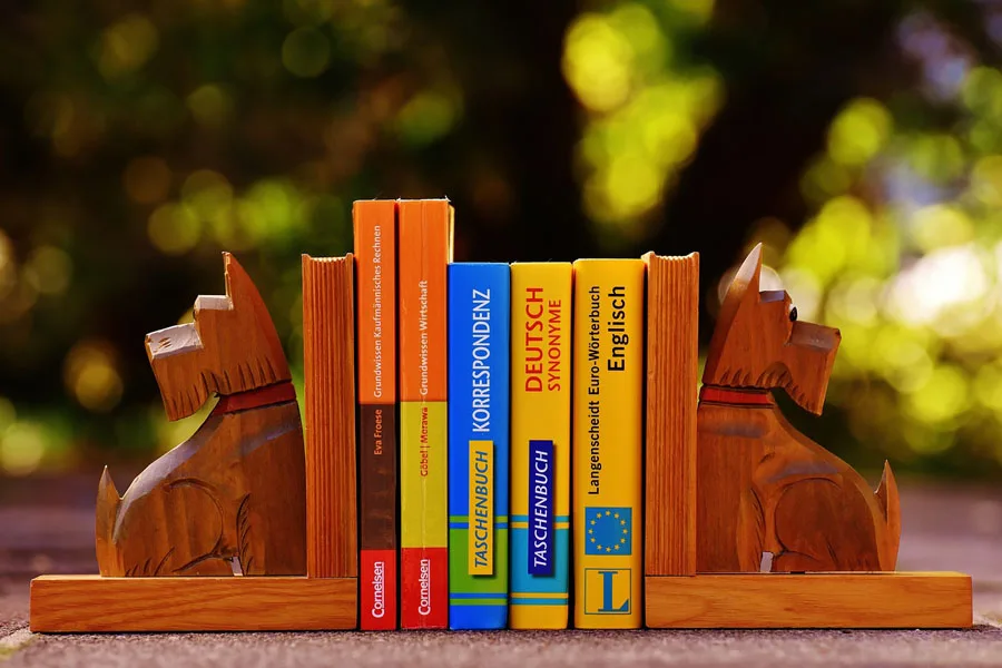  wooden book ends with heavy books in between