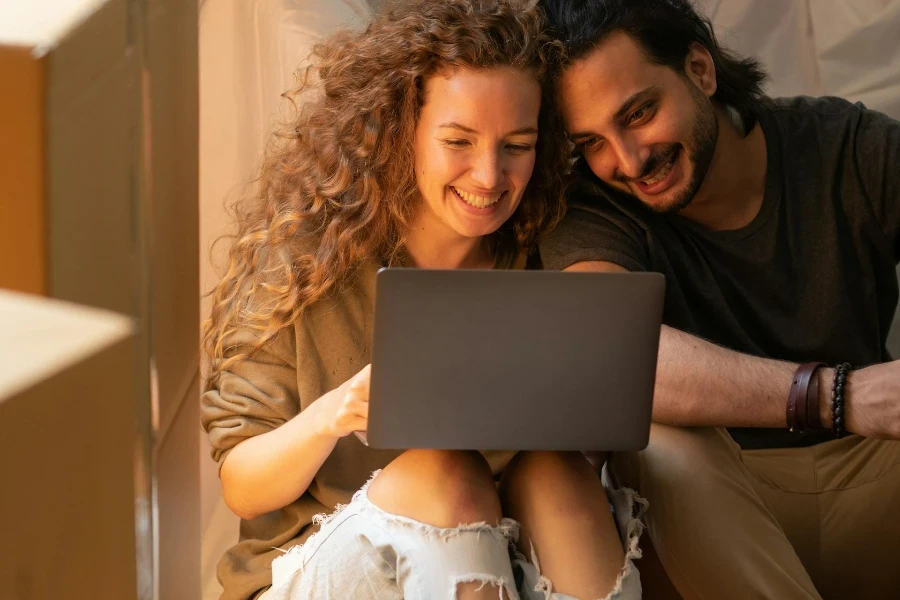 Young couple on a sofa using a laptop