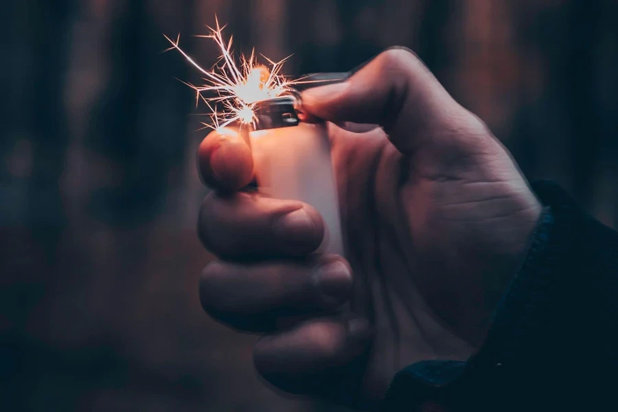 A Person Using a Lighter To Light up a Sparkle