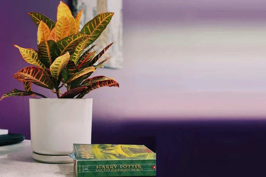 A White Planter With an Artificial Plant on a Table