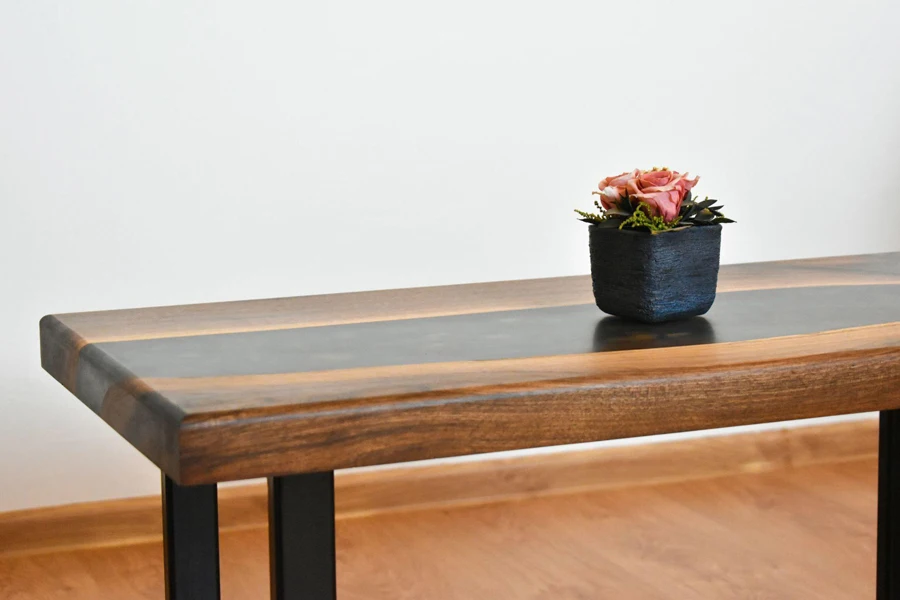 A Wooden Table With a Flower Pot Placed on It