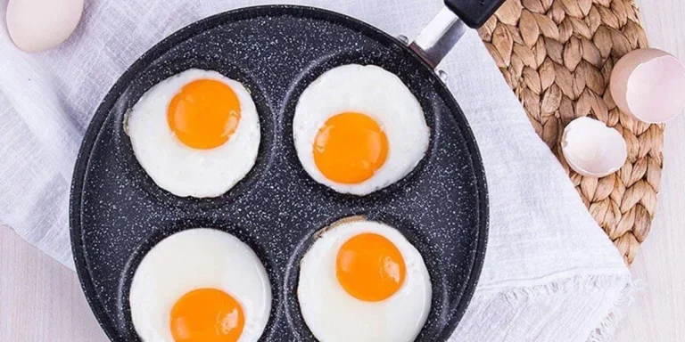 A frying pan handling four eggs